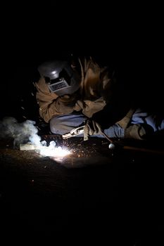 a welder working at shipyard during night shift