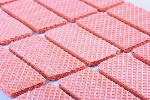 Pink sweet wafers are laid out by equal numbers.