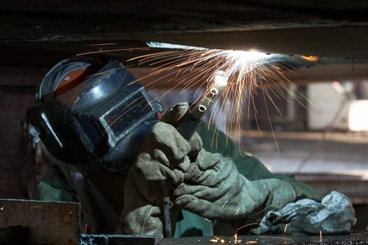 a welder working at shipyard during day