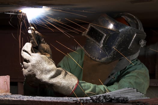 a welder working at shipyard during night shift