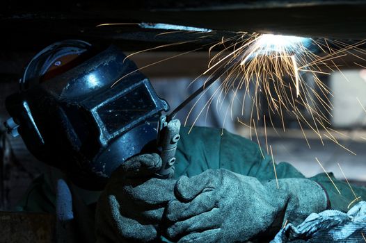 a welder working at shipyard during day