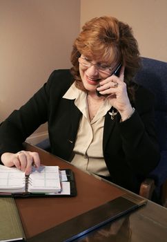 Senior Woman Executive Talking on Phone with agenda
