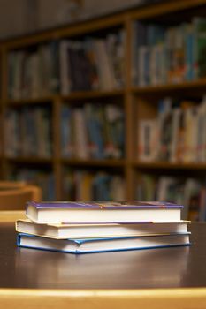 three books stacked on a table