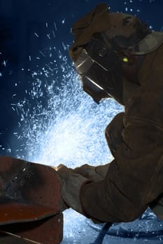 an arc welder spraying a lot of fire