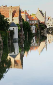 Canal with reflection of houses