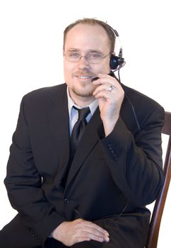 Young business man with headset talking on phone