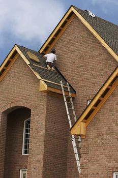 roofer working on house