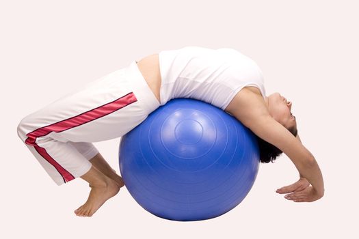 Woman doing Pilates Exercises with ball