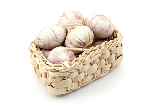 garlic in a basket isolated on white background