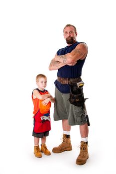 Caucasian middle aged father and cute young son ready to do a construction job. Man and boy wearing tool belt with hammer, shorts and boots, standing with arms crossed. Isolated.