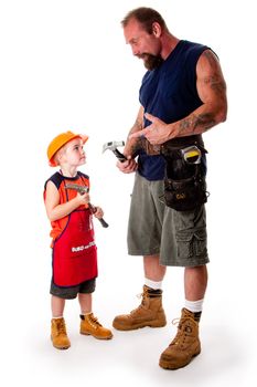 A big guy father with his son, carpenters, holding hammers while dad is explaining by pointing at his tool, isolated.