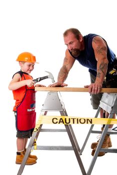Father is teaching son how to use a hammer, trying to hit a nail into a wood board, isolated.