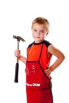 Cute young boy holding heavy duty hammer and wearing orange apron with pockets for tools, isolated.