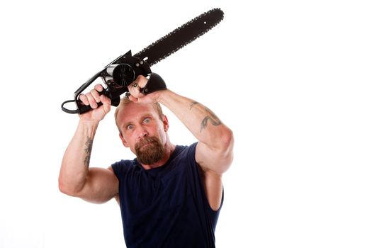 Crazy Caucasian man with tattoos and chainsaw above his head with strong expression in eyes, isolated.