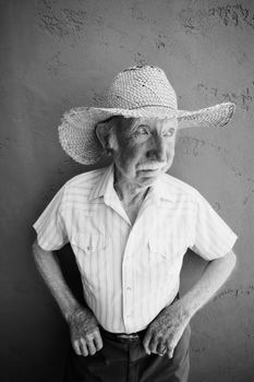 Senior Citizen Man Wearing a Straw Cowboy Hat Looks Off