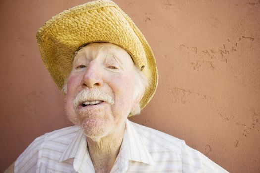 Senior Citizen Man with a Funny Expression Wearing a Straw Cowboy Hat