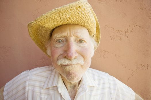 Senior Citizen Man with a Funny Expression Wearing a Straw Cowboy Hat