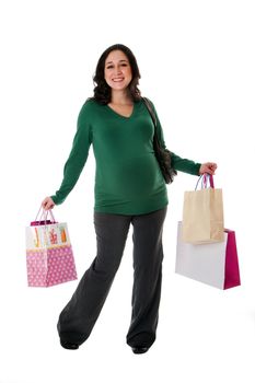 Beautiful happy exciting smiling Caucasian pregnant brunette woman holding shopping bags while standing, isolated