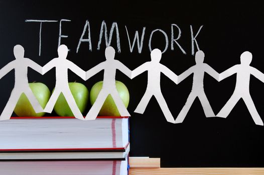 chalkboard and apples showing a concept for teamwork