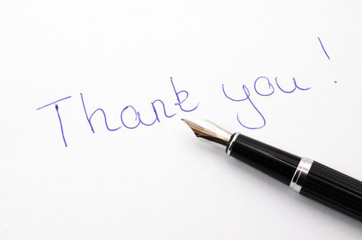 thank you message on paper with pen