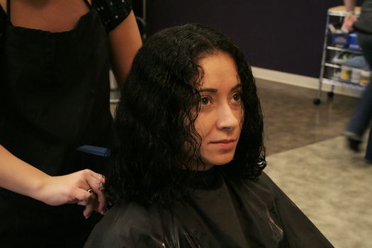 Woman getting a haircut in a salon