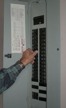 Man doing maintenance on a electrical box