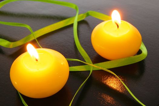 yellow candles showing spa or welllness concept