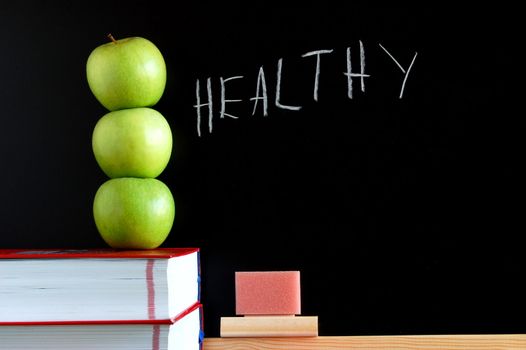 apples books and chalkboard showing healthy lifestyle