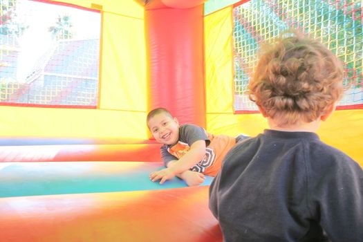 kids playing in inflatable air castle