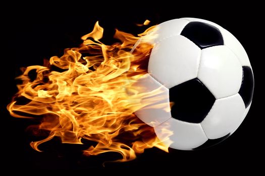 An image of a leather soccer ball in flames soaring through the air.
