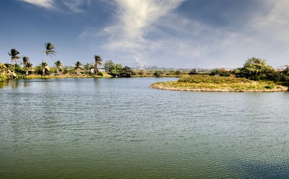 Rural scenic of lake and grassland in tropical area.