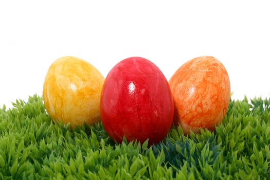 three easter eggs on green grass