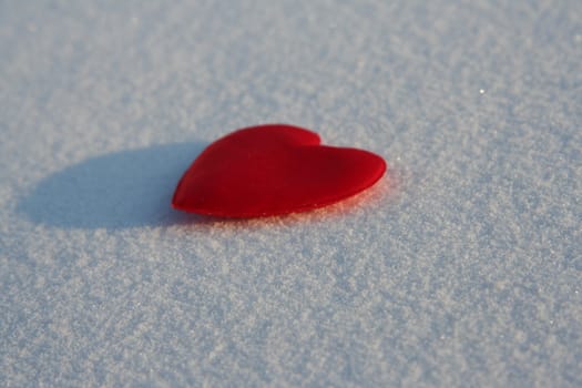 Red silk heart on the snow