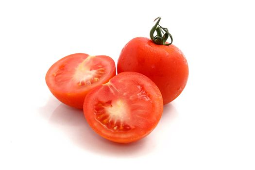 cut red tomatoes on a white background
