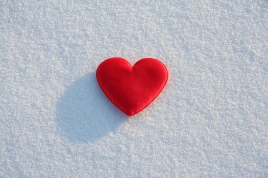 
Red silk heart on the snow