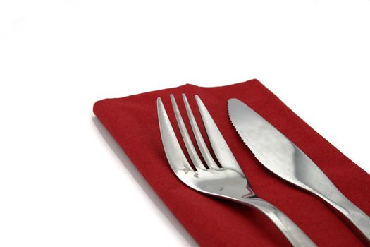 a fork and a knife on a red napkin