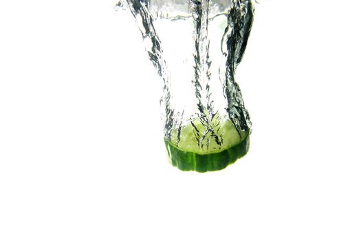 a slice of cucumber splashing into water