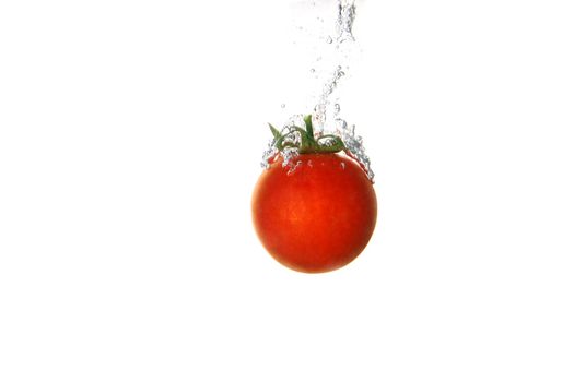 a tomato splashing into water