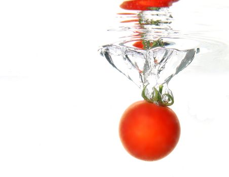 a tomato splashing in water