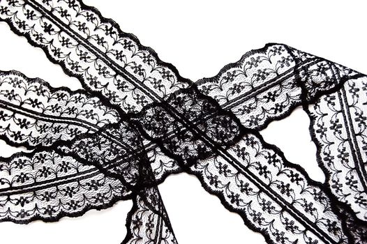 Black delicate lace on white background