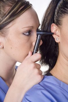 Young doctor looking in womans ear