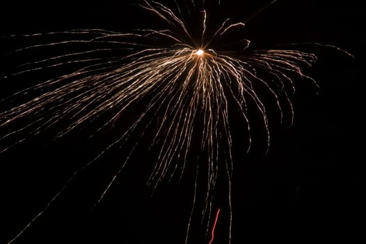 long exposure of multiple fireworks against a black sky