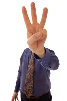 A senior businessman, in shirtsleeves, indicating 'three' with his fingers.