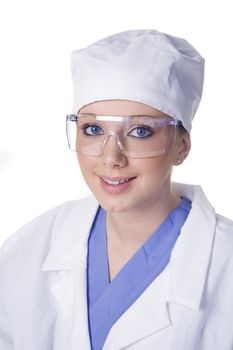 Young scientist in laboratory with scrubs and lab coat and safety glasses