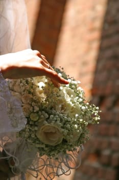 The bride holds a wedding bouquet