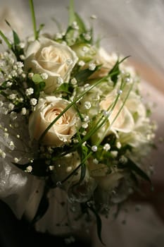 The bride holds a wedding bouquet