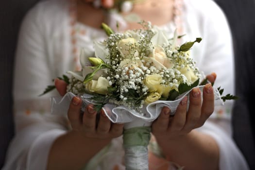 The bride holds a wedding bouquet