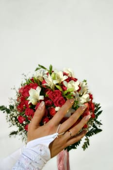 Wedding bouquet in a hand of the bride