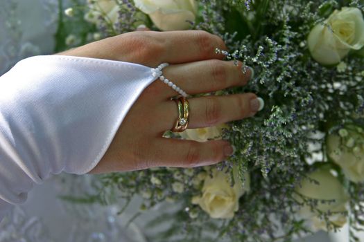 Wedding bouquet in a hand of the bride