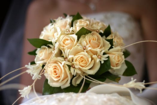 The bride holds a wedding bouquet